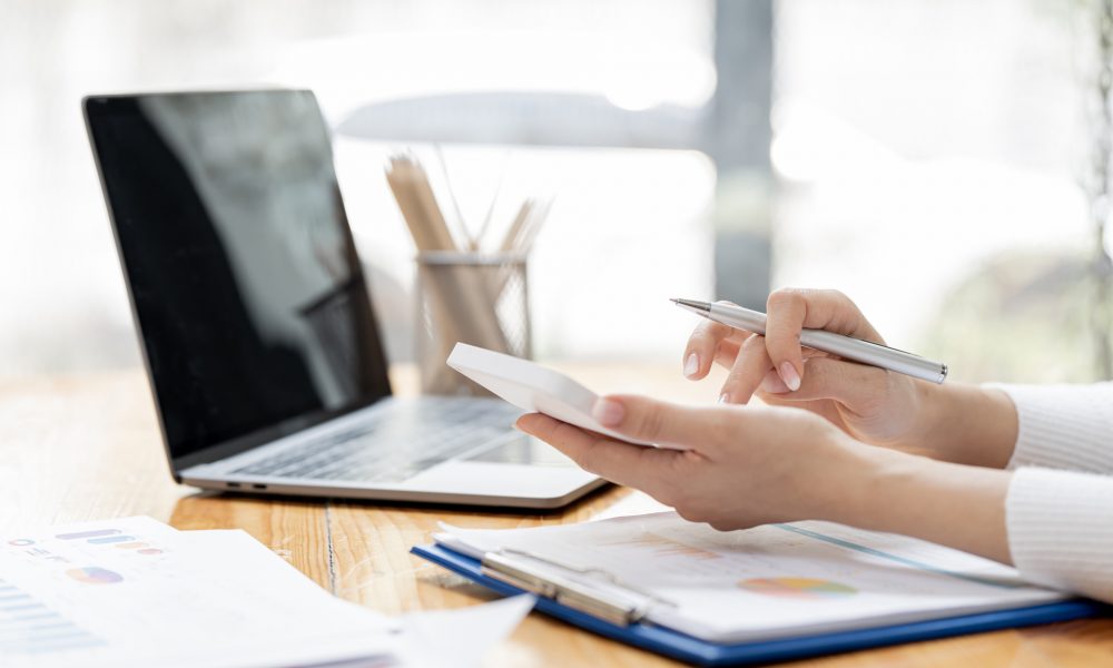 Accountant working Financial investment on calculator, calculate Accountant working Financial investment on calculator, calculate, analyze business and marketing growth on financial document data graph