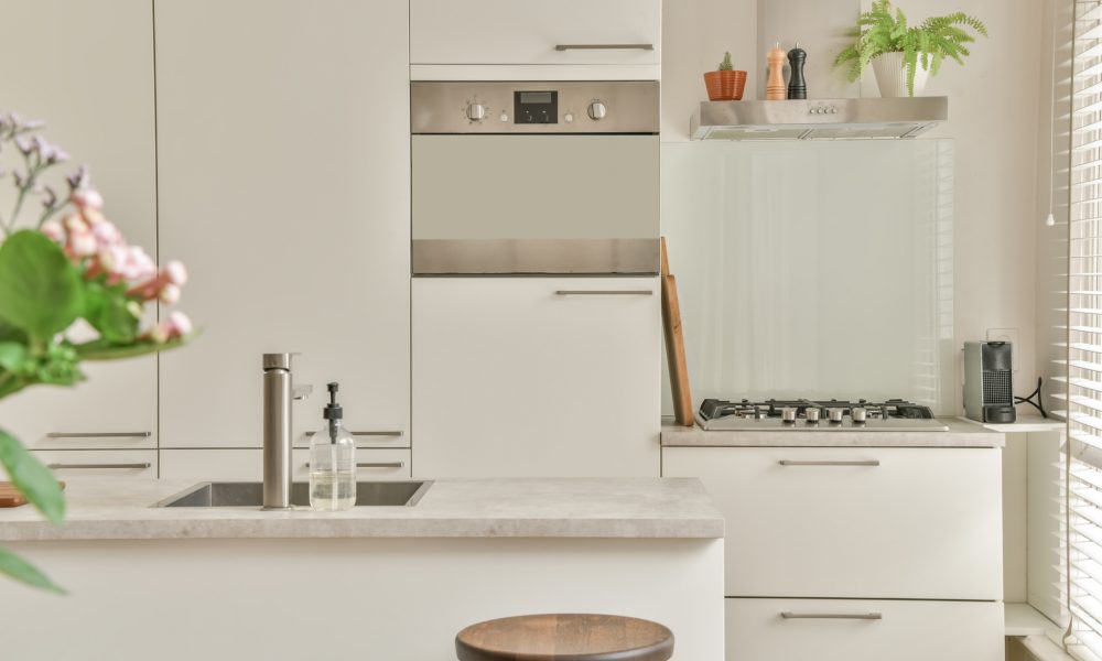 The interior of the kitchen The interior of the kitchen in white tones on the parquet floor in a modern house